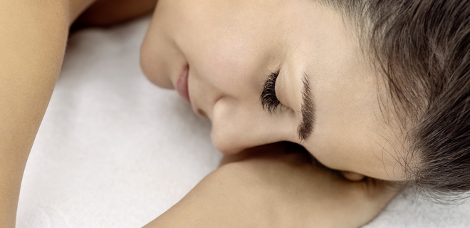 Detailaufnahme Frau legt Kopf auf die Hände während einer Massage im besten Wellnessbad der Schweiz.